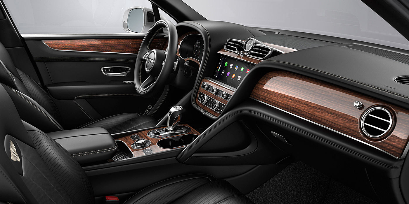 Bentley Shanghai - Pudong Bentley Bentayga interior with a Crown Cut Walnut veneer, view from the passenger seat over looking the driver's seat.
